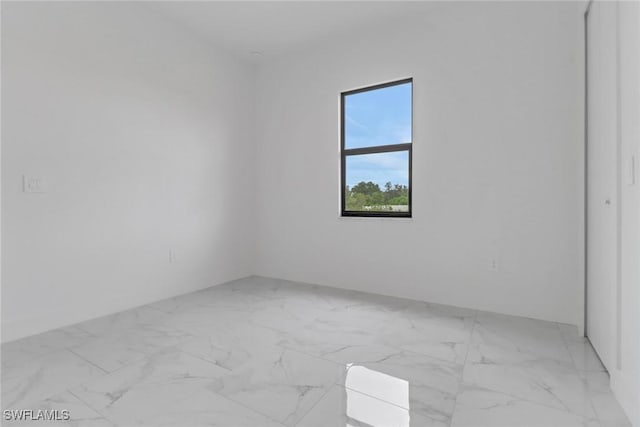 2712 58th St W, Lehigh Acres, FL 33971 - empty room featuring light marble finish flooring
