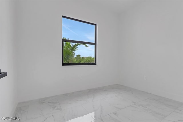 2712 58th St W, Lehigh Acres, FL 33971 - unfurnished room featuring marble look tiles and baseboards