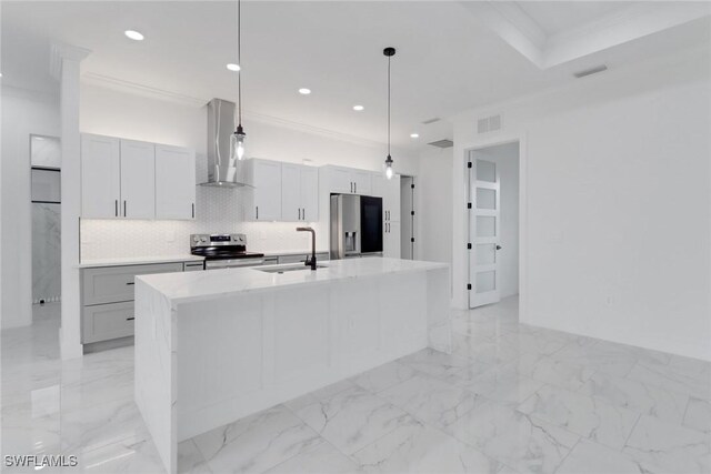 2712 58th St W, Lehigh Acres, FL 33971 - kitchen with stainless steel appliances, wall chimney range hood, a sink, a center island with sink, and decorative backsplash