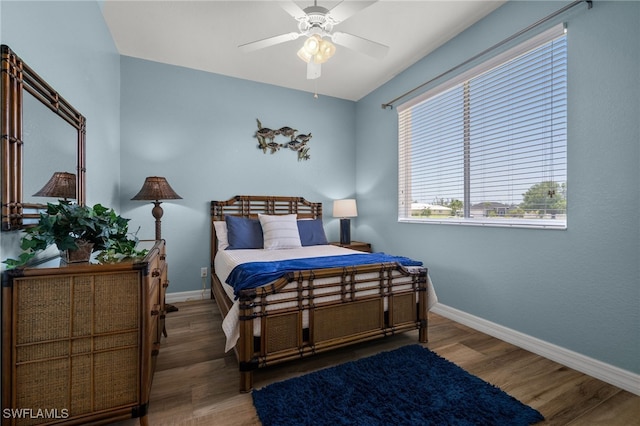 bedroom featuring baseboards and wood finished floors