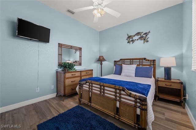 bedroom featuring wood finished floors, baseboards, and a ceiling fan