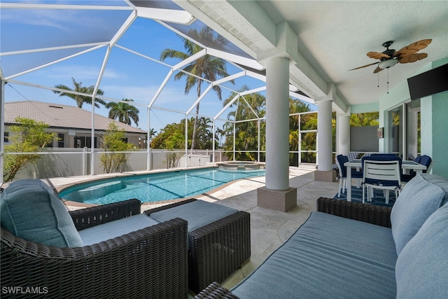 view of swimming pool with a patio area, ceiling fan, a pool with connected hot tub, a lanai, and fence