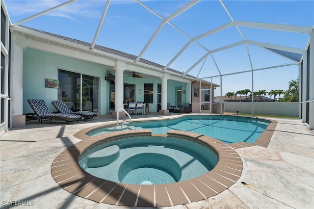 view of swimming pool with a patio, ceiling fan, a pool with connected hot tub, and a lanai