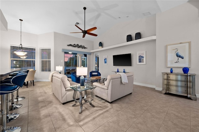 living area featuring high vaulted ceiling, a ceiling fan, light tile patterned floors, and baseboards