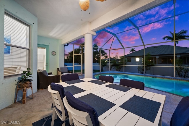 outdoor pool featuring a patio area, ceiling fan, and a lanai