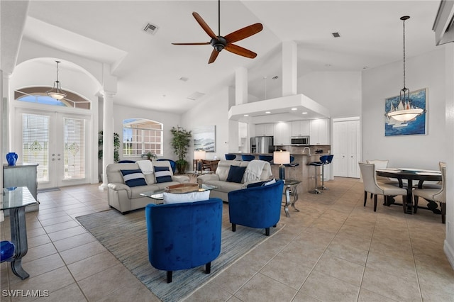 living room featuring ornate columns, high vaulted ceiling, a ceiling fan, and light tile patterned floors