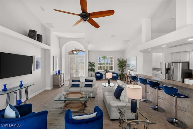living room featuring light tile patterned flooring, french doors, a ceiling fan, washer / clothes dryer, and recessed lighting