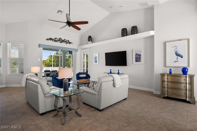 tiled living room with a ceiling fan, high vaulted ceiling, and baseboards
