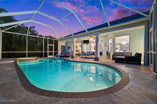 swimming pool with a patio area, an outdoor hangout area, a jacuzzi, a ceiling fan, and glass enclosure