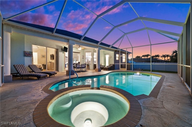 view of swimming pool with a pool with connected hot tub, a patio area, ceiling fan, and a lanai