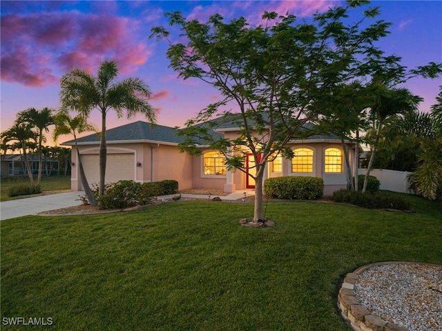 ranch-style house with driveway, stucco siding, and a garage