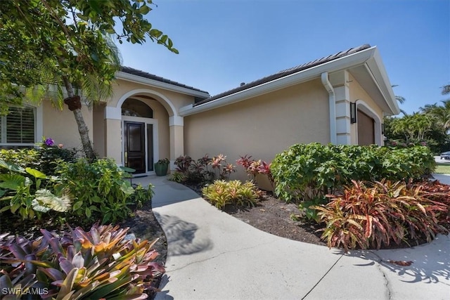 600 Port Side Dr, Naples, FL 34103 - doorway to property with stucco siding