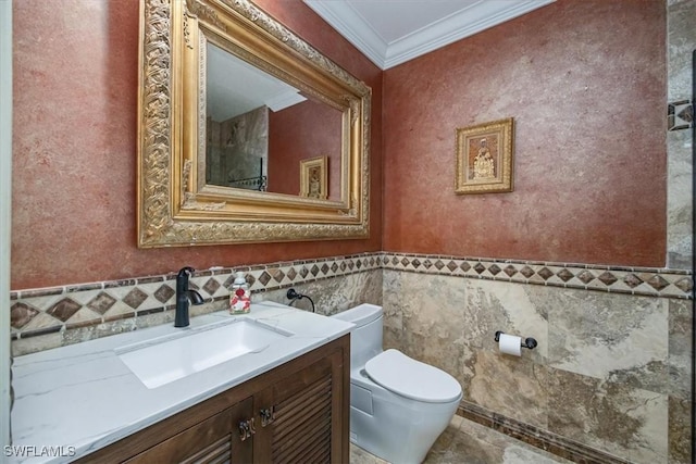 600 Port Side Dr, Naples, FL 34103 - bathroom with tile walls, crown molding, toilet, vanity, and a wainscoted wall