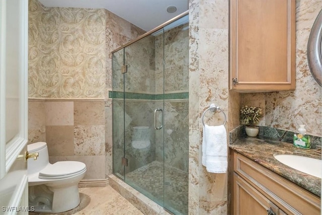 600 Port Side Dr, Naples, FL 34103 - bathroom featuring a shower stall, toilet, vanity, and tile walls