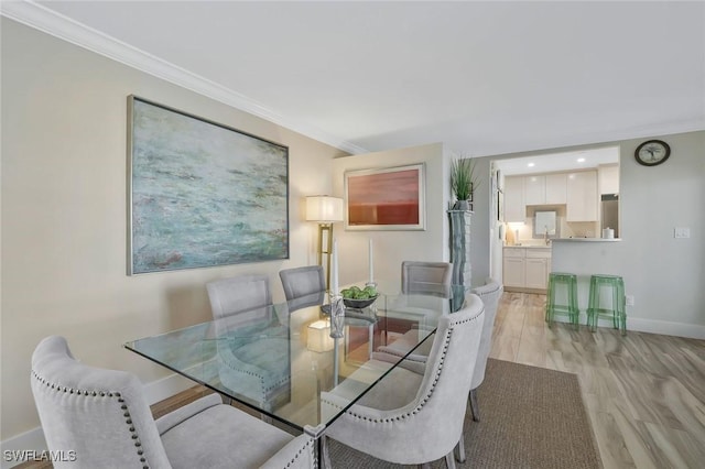 683 12th Ave S Unit 683, Naples, FL 34102 - dining area with baseboards, ornamental molding, and light wood-style floors