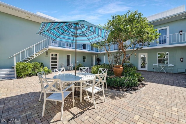 683 12th Ave S Unit 683, Naples, FL 34102 - view of patio / terrace with stairs and outdoor dining area