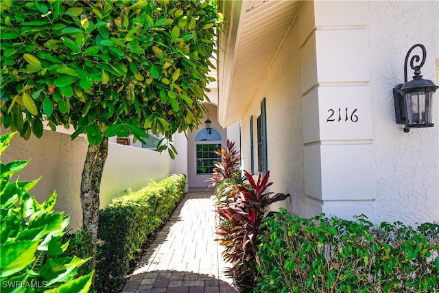 2116 Paget Cir Unit 1, Naples, FL 34112 - doorway to property with stucco siding