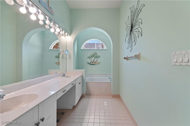 2116 Paget Cir Unit 1, Naples, FL 34112 - bathroom with tile patterned floors, double vanity, a garden tub, and baseboards