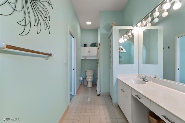 2116 Paget Cir Unit 1, Naples, FL 34112 - bathroom with toilet, vanity, tile patterned floors, and baseboards