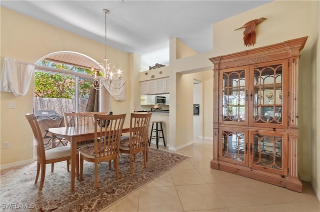 2116 Paget Cir Unit 1, Naples, FL 34112 - tiled dining area featuring a chandelier and baseboards