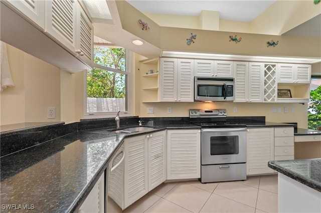 2116 Paget Cir Unit 1, Naples, FL 34112 - kitchen featuring stainless steel appliances, a sink, open shelves, light tile patterned floors, and dark stone countertops