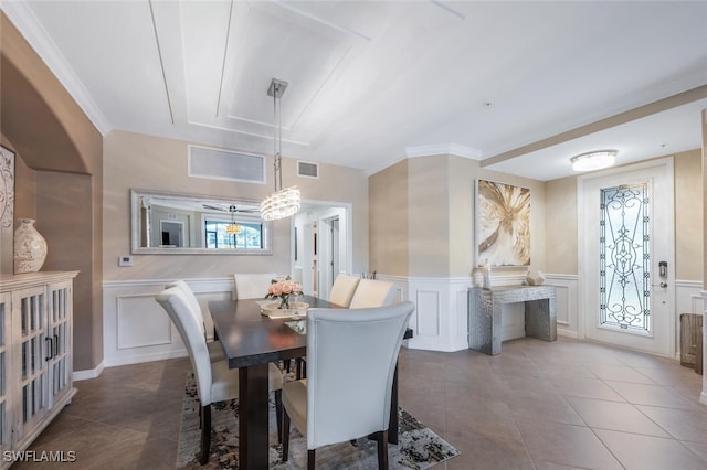 9469 Casoria Ct Unit 101, Naples, FL 34113 - dining space with a decorative wall, tile patterned floors, a wainscoted wall, and a chandelier