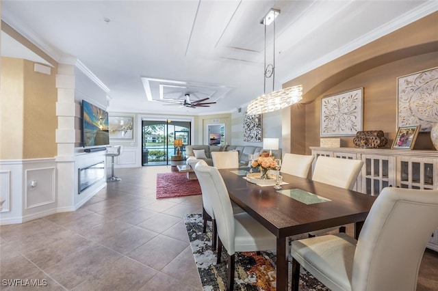 9469 Casoria Ct Unit 101, Naples, FL 34113 - dining area featuring a large fireplace, ornamental molding, tile patterned floors, and ceiling fan