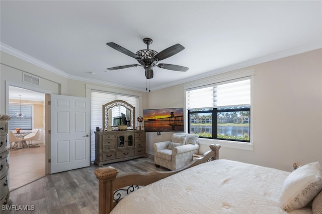 9469 Casoria Ct Unit 101, Naples, FL 34113 - bedroom featuring ornamental molding, wood finished floors, and ceiling fan
