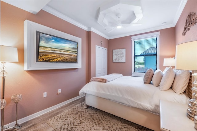 9469 Casoria Ct Unit 101, Naples, FL 34113 - bedroom featuring wood finished floors, baseboards, crown molding, and a closet