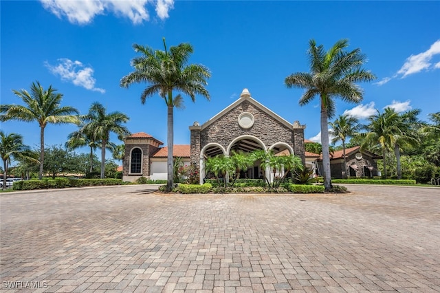 9469 Casoria Ct Unit 101, Naples, FL 34113 - mediterranean / spanish-style home featuring curved driveway