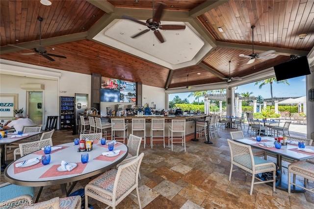 9469 Casoria Ct Unit 101, Naples, FL 34113 - view of patio featuring ceiling fan, a bar, and a wall mounted air conditioner