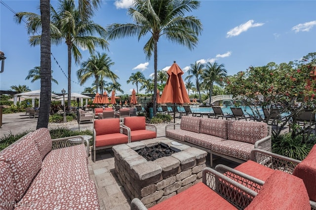 9469 Casoria Ct Unit 101, Naples, FL 34113 - view of patio / terrace with a community pool and an outdoor living space with a fire pit