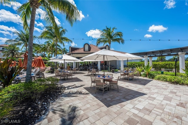 9469 Casoria Ct Unit 101, Naples, FL 34113 - view of patio with outdoor dining area and a pergola