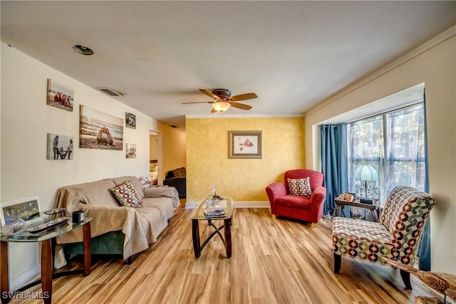 5905 Untermeyer Ct, North Fort Myers, FL 33903 - living room with light wood-style floors, a ceiling fan, baseboards, and crown molding