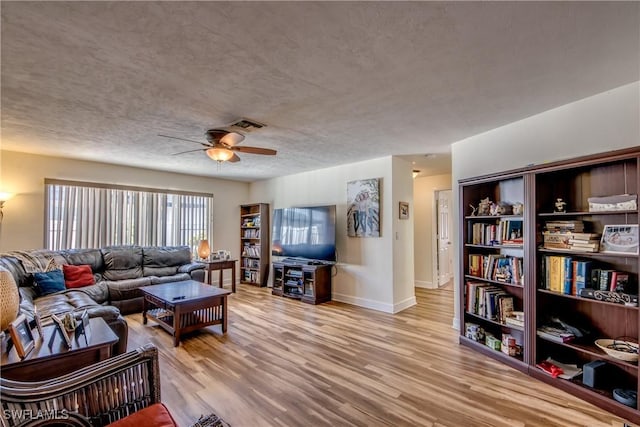 5905 Untermeyer Ct, North Fort Myers, FL 33903 - living room featuring a ceiling fan, baseboards, wood finished floors, and a textured ceiling