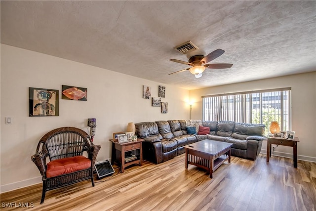 5905 Untermeyer Ct, North Fort Myers, FL 33903 - living area featuring a ceiling fan, light wood-type flooring, baseboards, and a textured ceiling