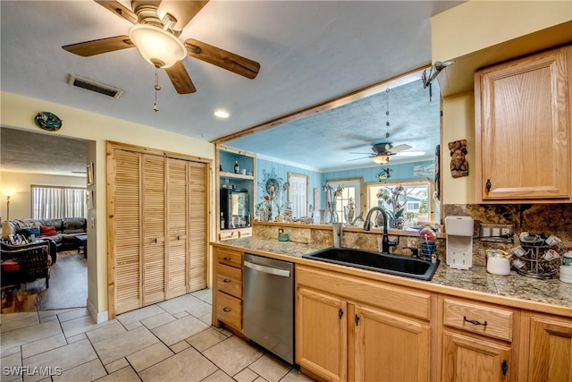 5905 Untermeyer Ct, North Fort Myers, FL 33903 - kitchen with stainless steel dishwasher, a sink, tile countertops, ceiling fan, and decorative backsplash