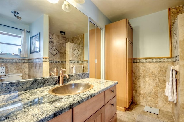 5905 Untermeyer Ct, North Fort Myers, FL 33903 - bathroom featuring tile walls, vanity, walk in shower, and a wainscoted wall