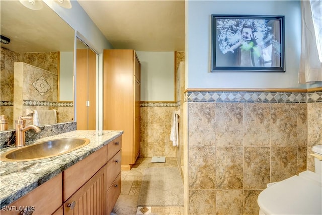 5905 Untermeyer Ct, North Fort Myers, FL 33903 - full bath with tile walls, vanity, toilet, and a wainscoted wall