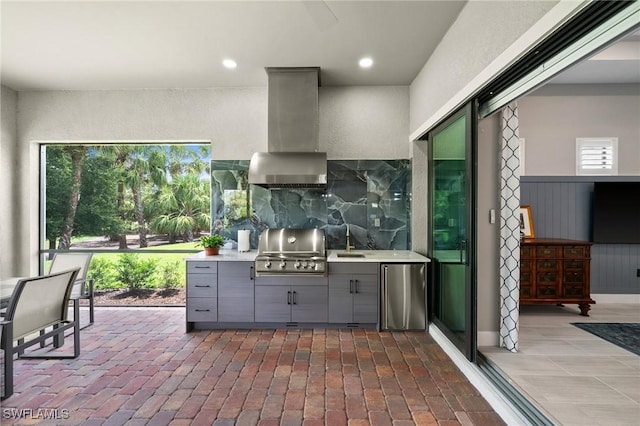 9284 Cormorant Dr, Naples, FL 34120 - kitchen with gray cabinets, ventilation hood, stainless steel fridge, a sink, and healthy amount of natural light