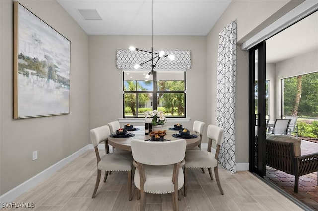 9284 Cormorant Dr, Naples, FL 34120 - dining room featuring baseboards and a chandelier