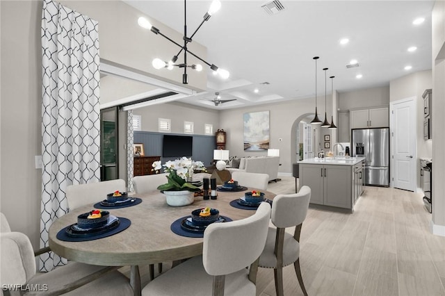 9284 Cormorant Dr, Naples, FL 34120 - dining space with recessed lighting, a chandelier, baseboards, and arched walkways