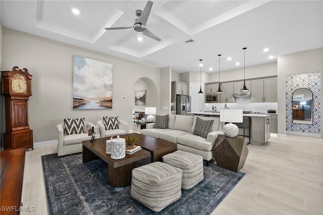 9284 Cormorant Dr, Naples, FL 34120 - living room featuring a ceiling fan, recessed lighting, arched walkways, baseboards, and coffered ceiling