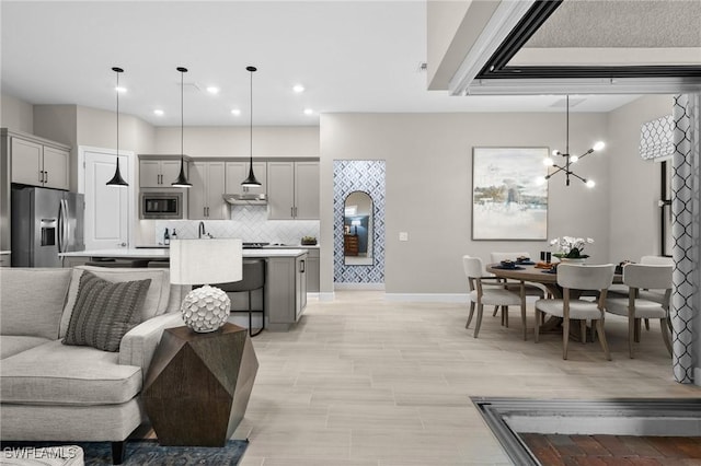 9284 Cormorant Dr, Naples, FL 34120 - living area featuring a chandelier, recessed lighting, and baseboards