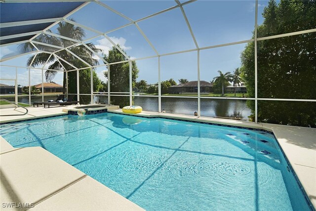 view of swimming pool featuring a patio area, a water view, a pool with connected hot tub, and a lanai