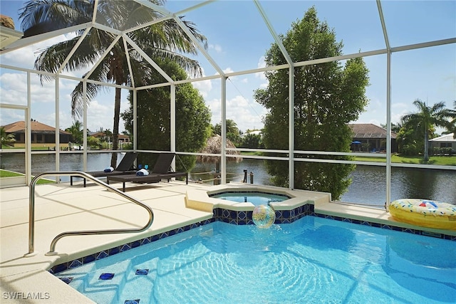 outdoor pool with a patio area, a water view, an in-ground hot tub, and glass enclosure