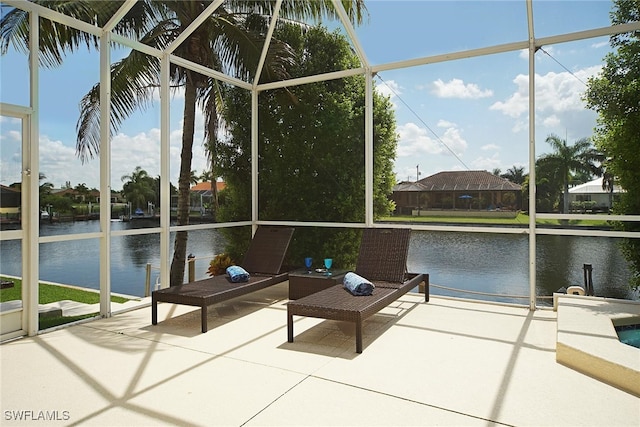 sunroom / solarium featuring a water view and plenty of natural light