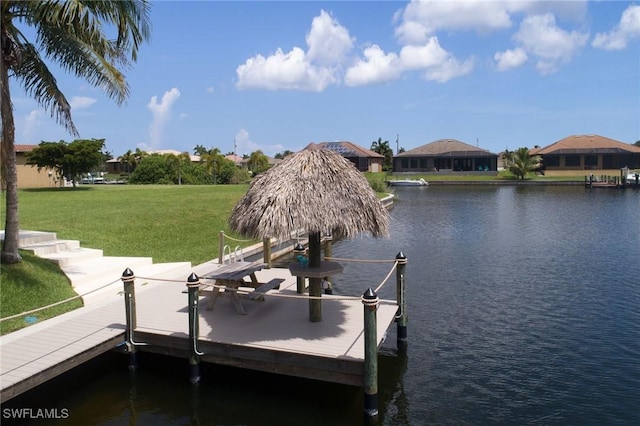 dock area featuring a yard and a water view