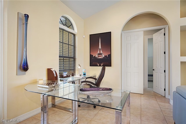 office space with baseboards and light tile patterned floors
