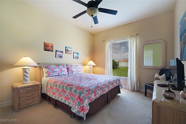 carpeted bedroom with baseboards and a ceiling fan